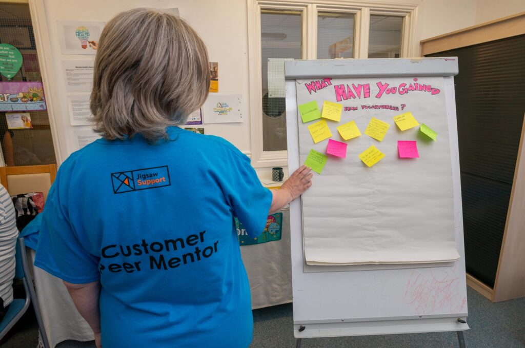 A Jigsaw Support volunteer in a volunteering and peer mentor t-shirt